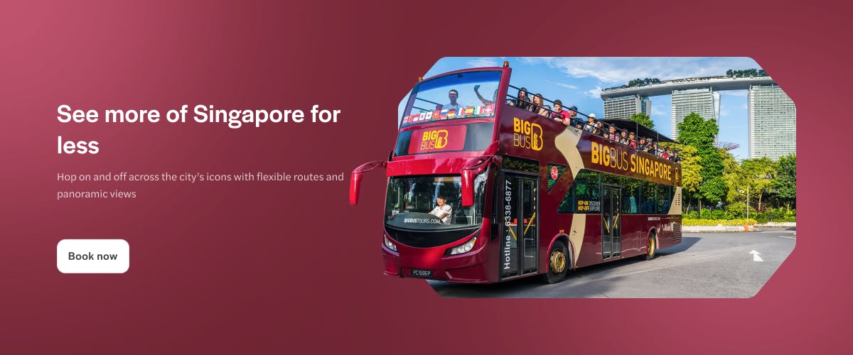 Tourists on a Singapore Hop-On-Hop-Off bus with Marina Bay Sands in the background.
